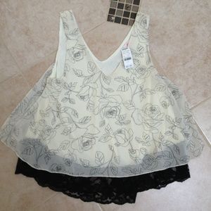 Cute black cream lace trimmed blouse. Never worn!