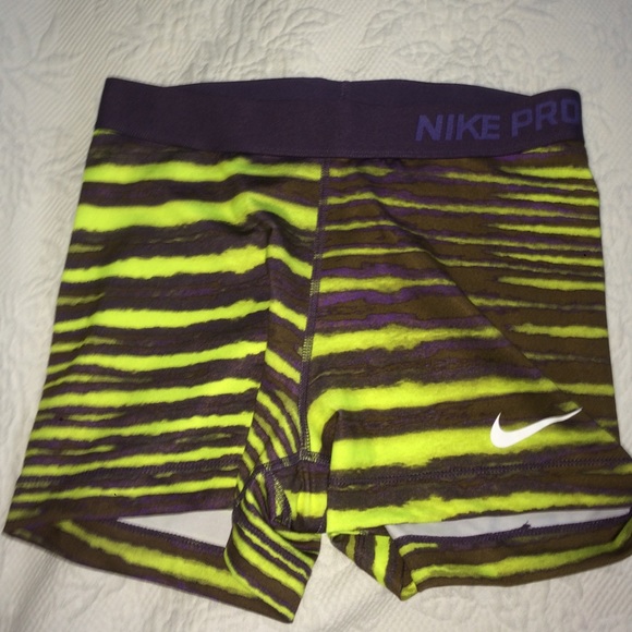 Purple and neon yellow striped Nike pros