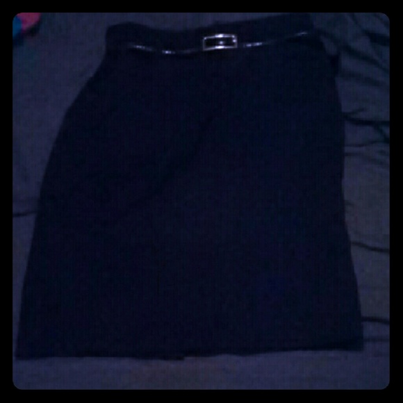 Black skirt hits just below the knee.