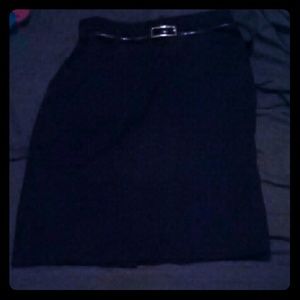 Black skirt hits just below the knee.