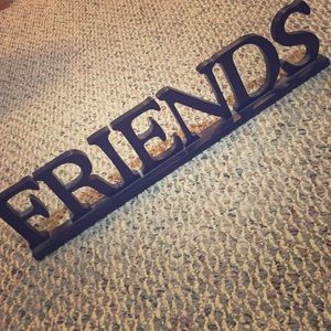 Not clothing but a "friends" sign