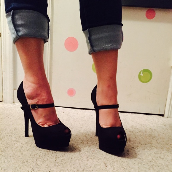 Black suede 5 inch stiletto peep toe pump.