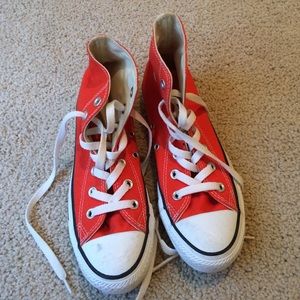 Orange high top converse.