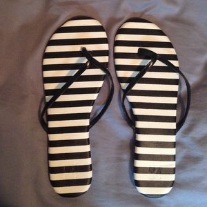 Black and white striped flip-flops