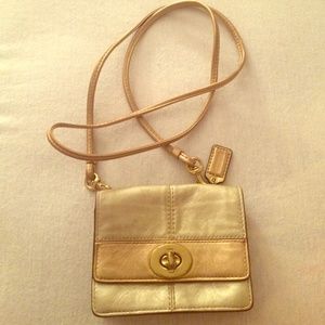 Coach cross body gold color.