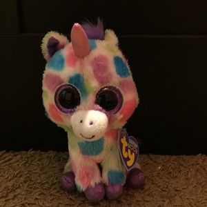 A beanie boo that has colorful dots and with tags