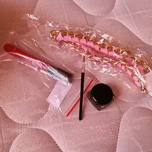 Necklace, lip gloss, and eye liner with brush