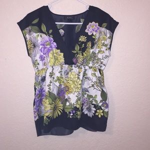 A flower print v cut shirt . Never worn.