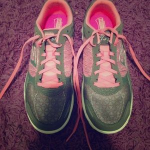 Pink and grey skechers with breast cancer logo.