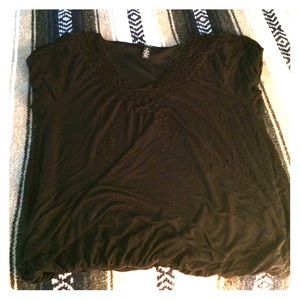 Black, styled, v-neck top.