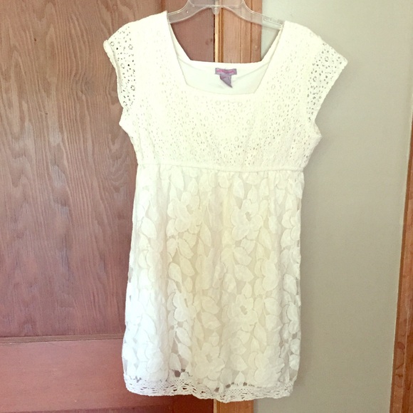 Cream colored, short sleeved dress.