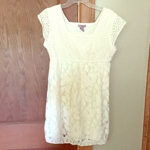 Cream colored, short sleeved dress.