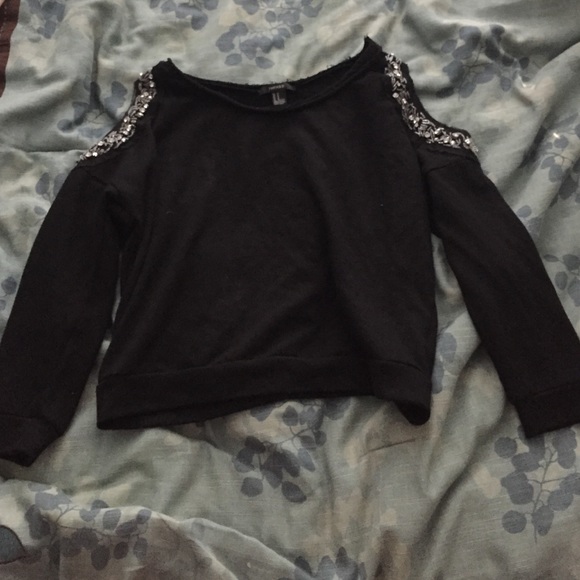 Black sweater with embellishments on shoulders