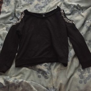 Black sweater with embellishments on shoulders