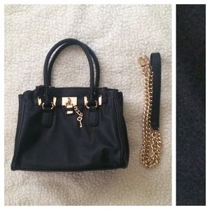 Black mini satchel crossbody bag.