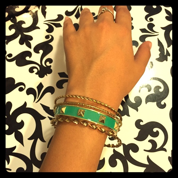 Gold bangles and green bracelet