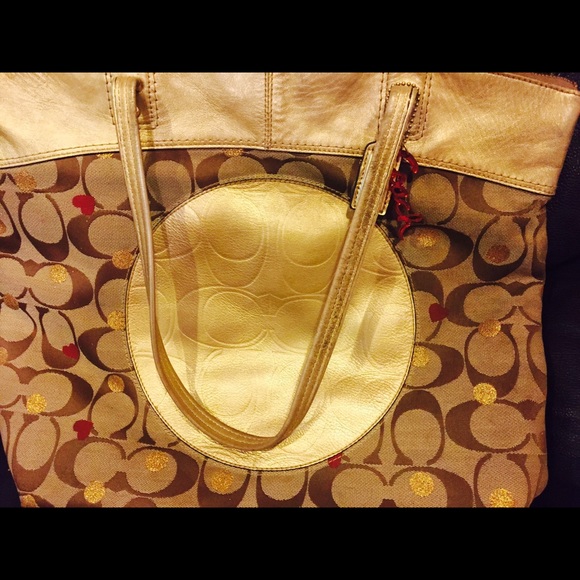 Coach pocketbook with gold and red hearts.