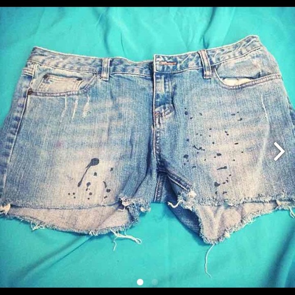 Paint-splattered denim shorts .