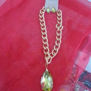 Gold necklace with a green diamond and earrings