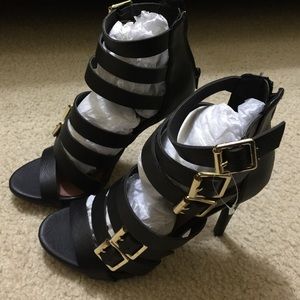 Black high heels with golden buckle