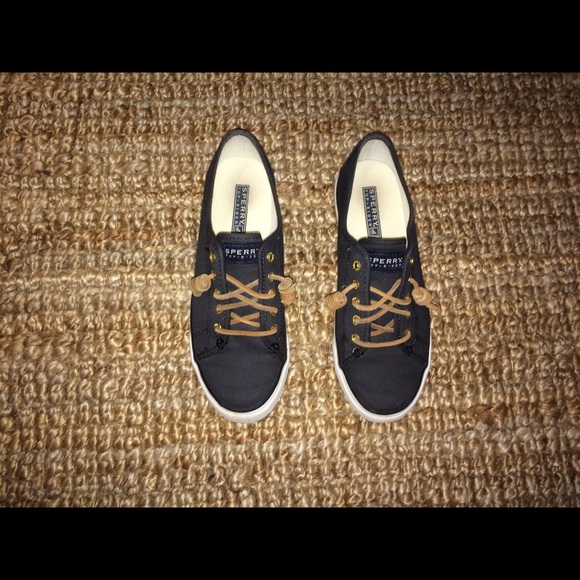 Black sperry shoes , tightened with tan laces