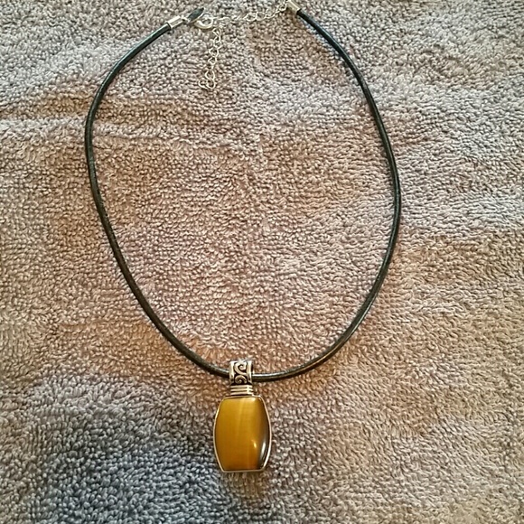 Leather rope necklace with additional charms.