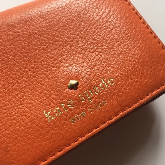 Orange Kate spade wallet in used condition