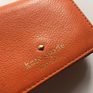 Orange Kate spade wallet in used condition