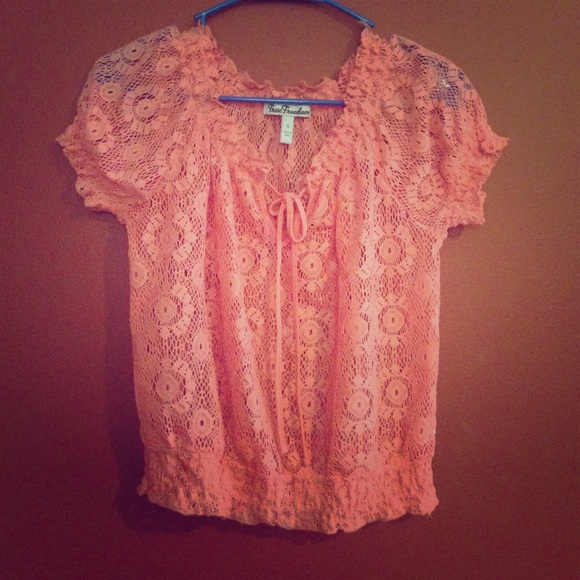 Coral colored top. It is a see through top.
