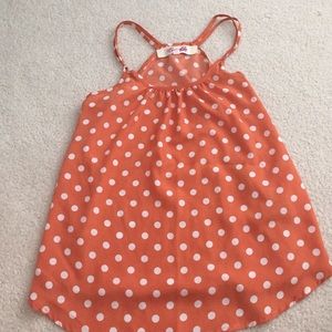 Orange and white polka dot tank top.