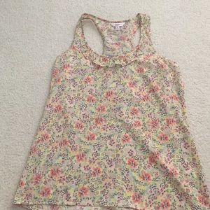 Floral racer back tank top with ruffle detail.