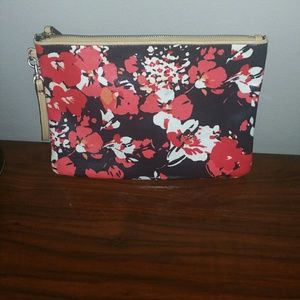 Floral clutch with faux leather trim.