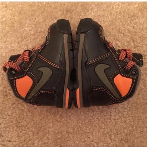 Brown, tan and green Nike toddler boots.