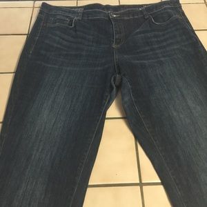 Dark rinse  distressed jeans.