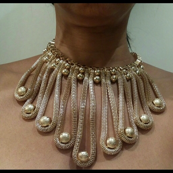 Gold tone ball drop necklace with earrings.
