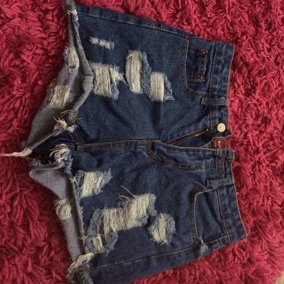 High waisted, slightly destroyed denim shorts