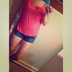 Salmon colored top with sheer shoulders