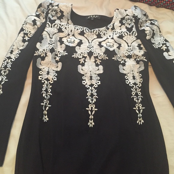 Gold patterned tight black dress.