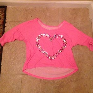 A pink shirt with a sequined heart. 3/4 sleeves