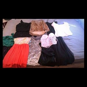 Lot of dresses ,shirts, and a skirt