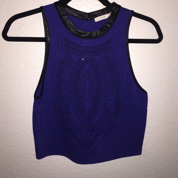 Blue top with cut outs and leather trimming
