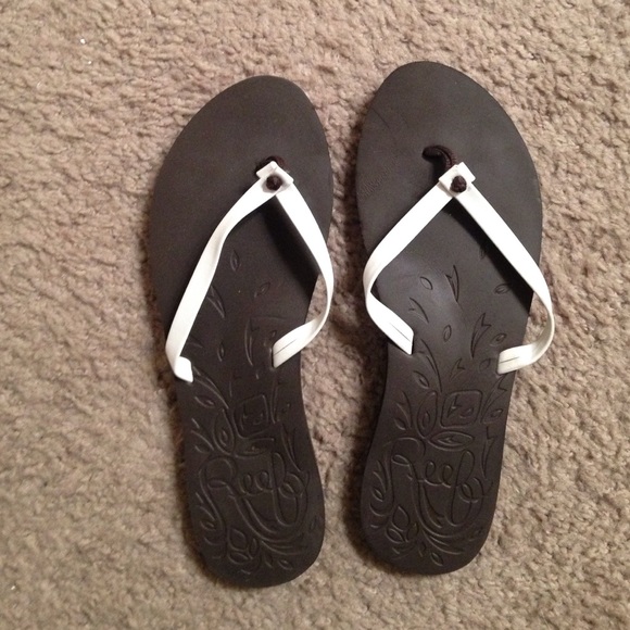 Brown and white flip flops