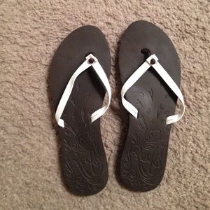 Brown and white flip flops