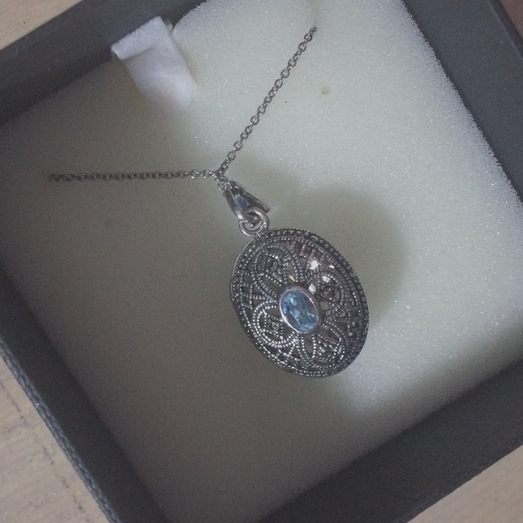 silver locket with sapphire pendant