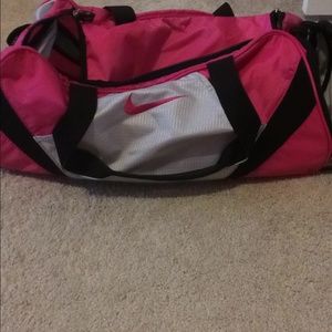 HOLDING ---Nike gym bag.