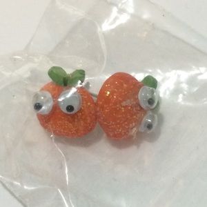 Googly eyed pumpkin earrings and pug shirt