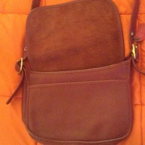 Red cross body coach bag.