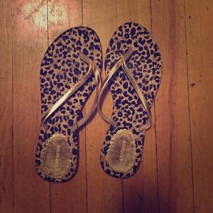 Gold and leopard flip flops