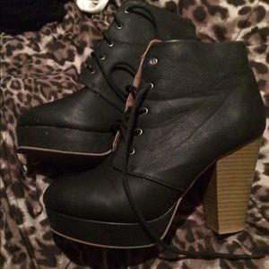 Black leather boots with heel.