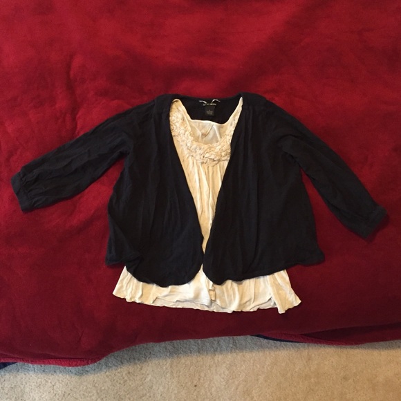 Black sweater and cream no sleeve blouse